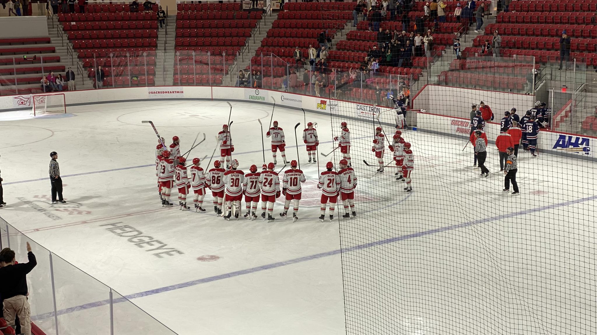 The Sacred Heart players salute the crowd after the game
