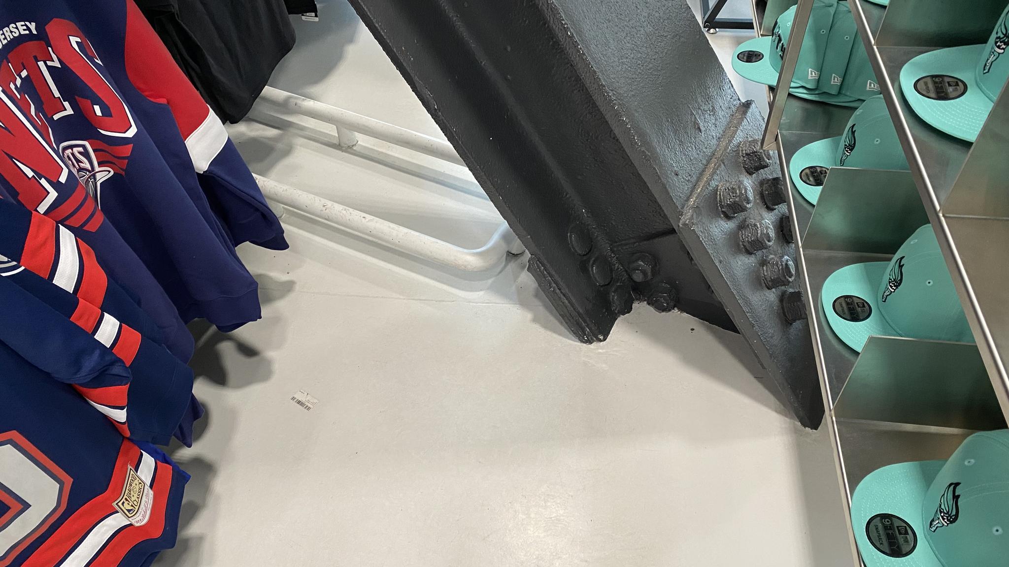 An image of a support beam blocking an aisle in the Barclays Center team store