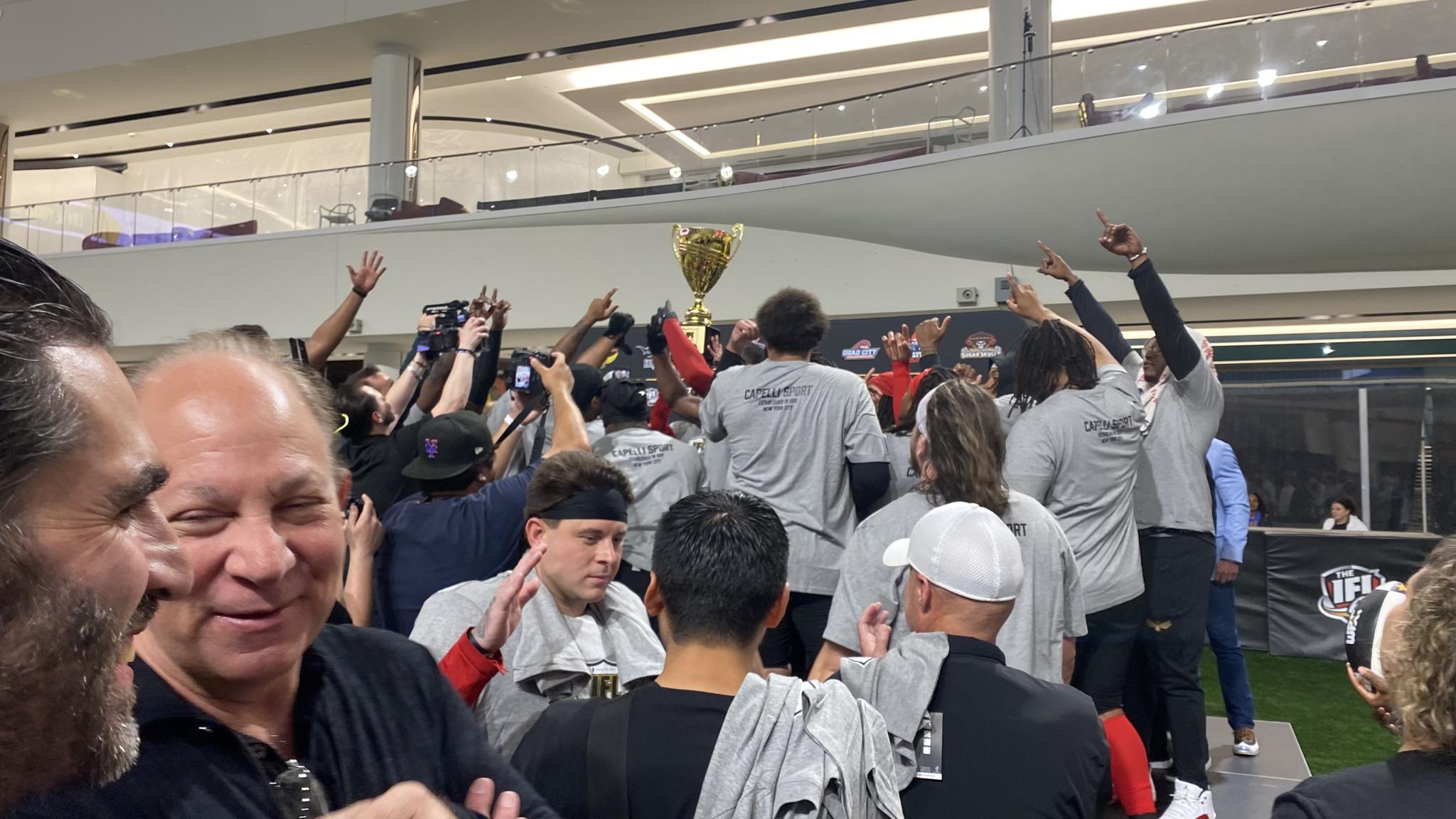 An image of the Vegas Knight Hawks lifting the IFL Cup trophy after winning it
