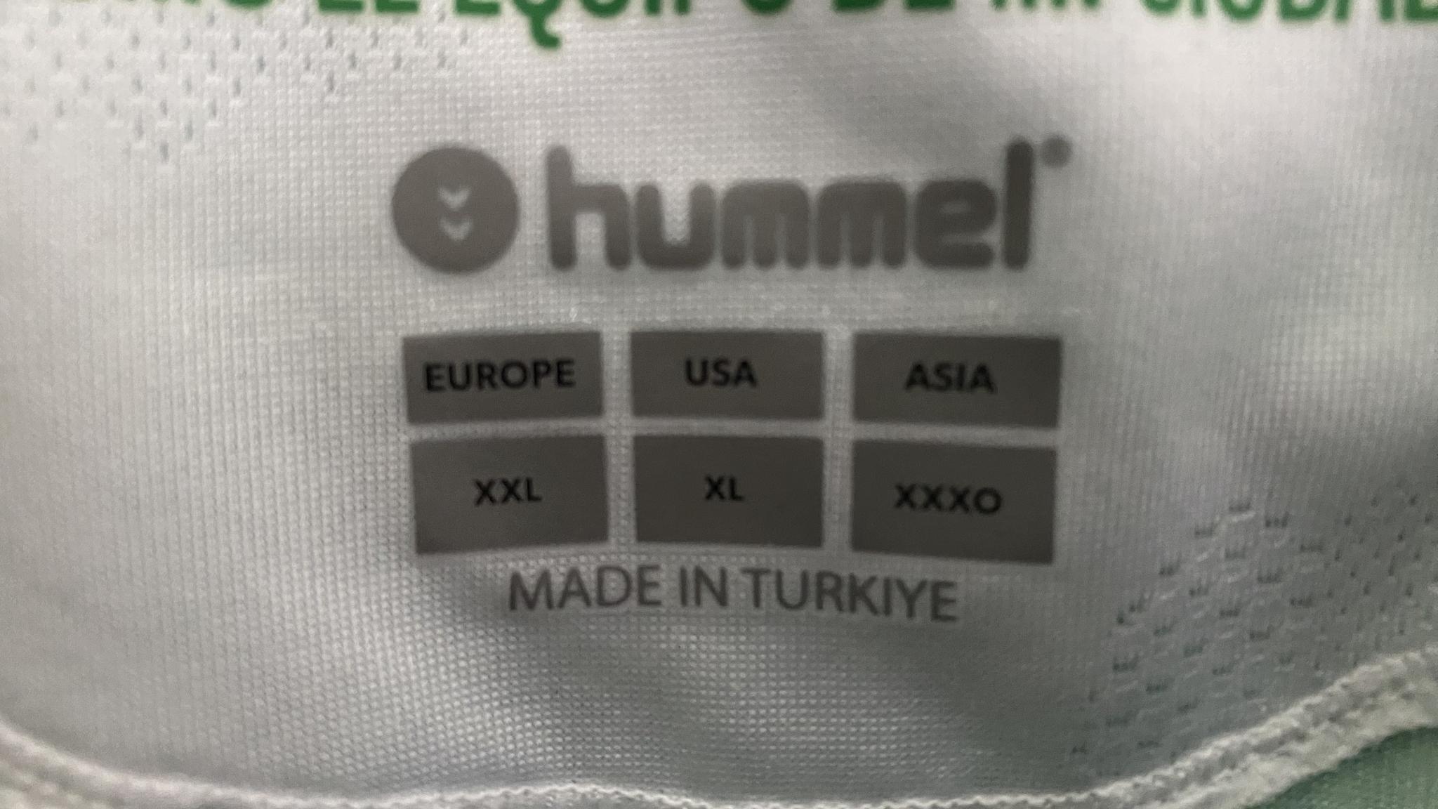 An image of the inside of a Hummel shirt. It contains size information which reads "EUROPE:XXL US:XL ASIA:XXXO"