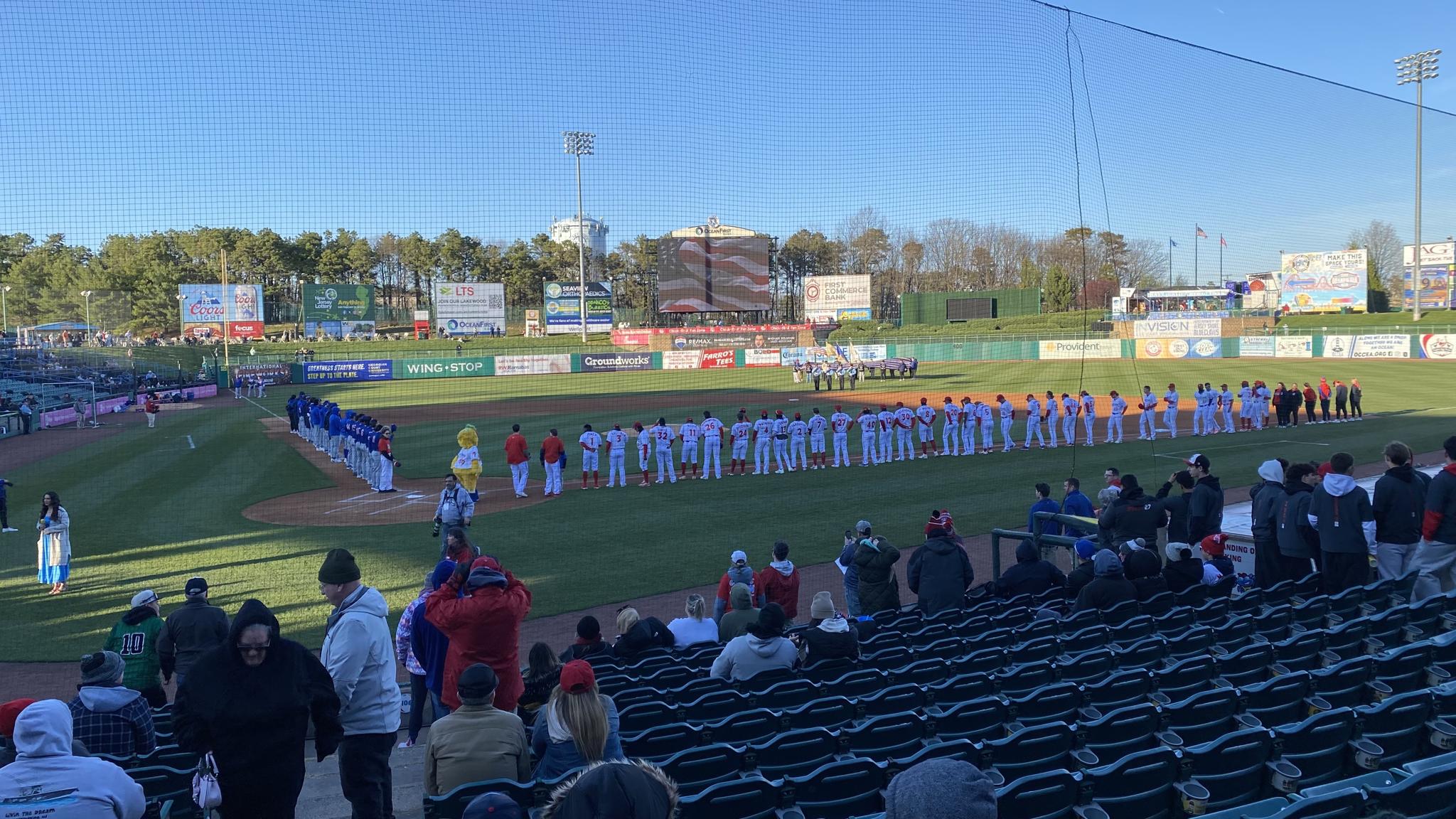 An image of two baseball teams lined up prior to the start of a game