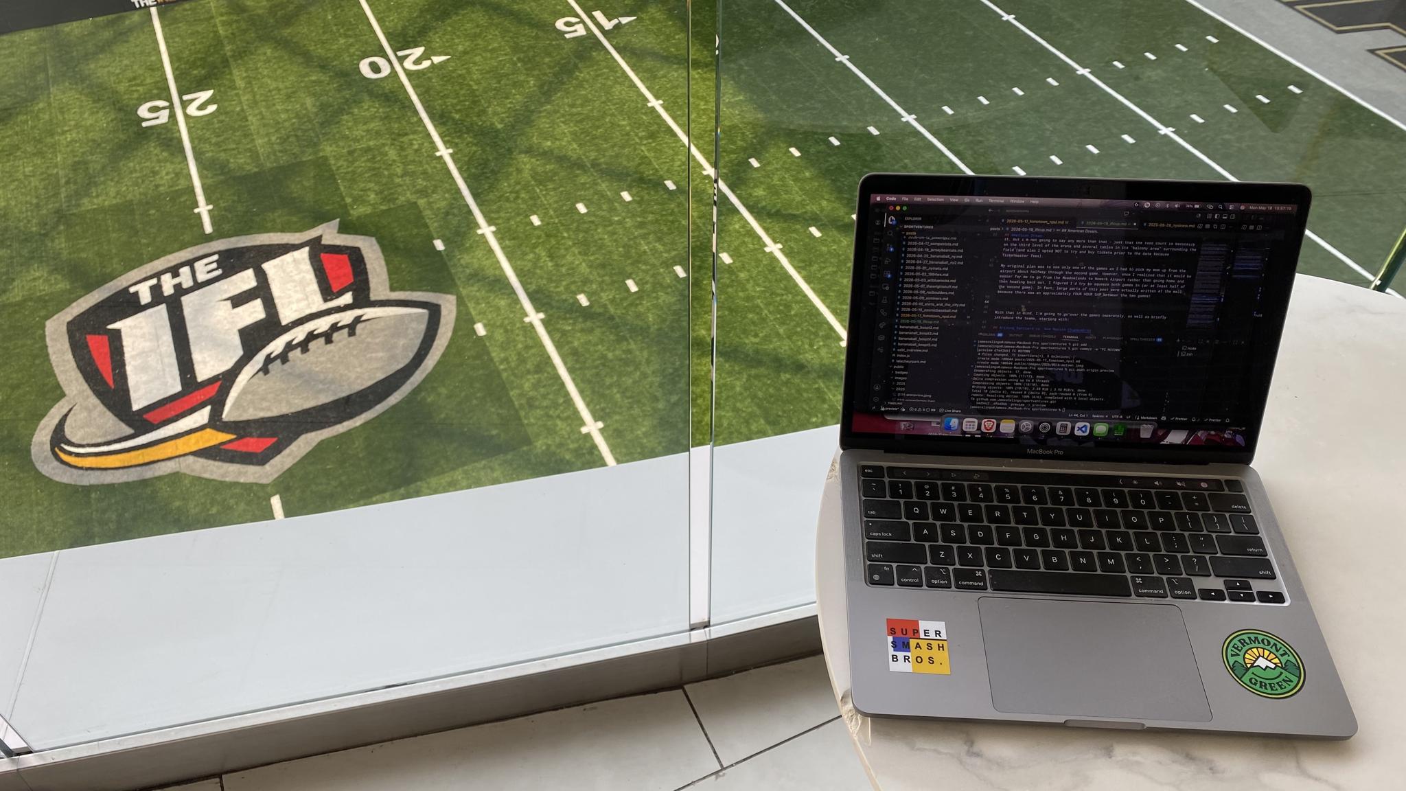 An image of a laptop high above an indoor football field