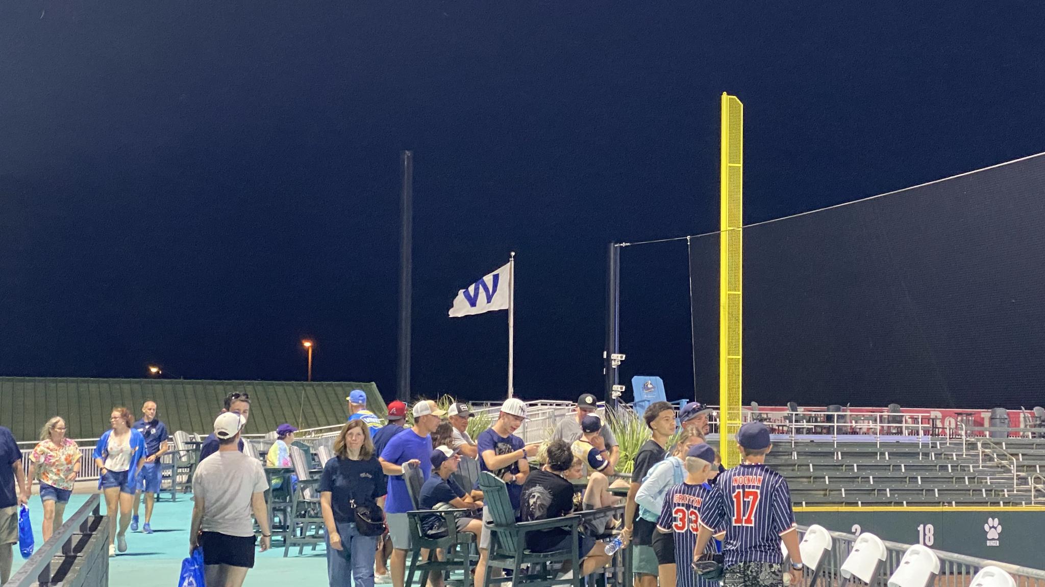 A flag with a "W" on in flies in the wind